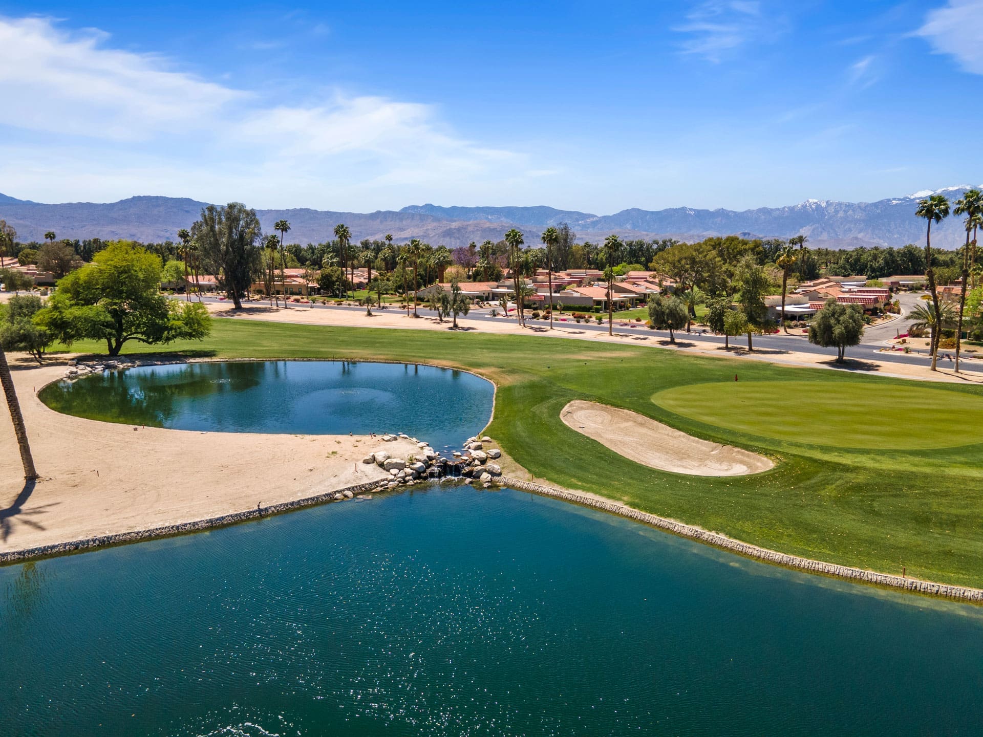 Aerial view of Palm Desert in California with blue lakes, homes and lots of palm trees