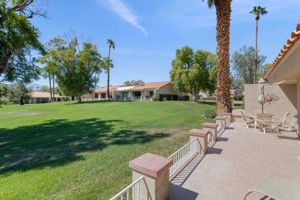 Rear view from patio of yard and homes in the area at 40386 Pebble Beach
