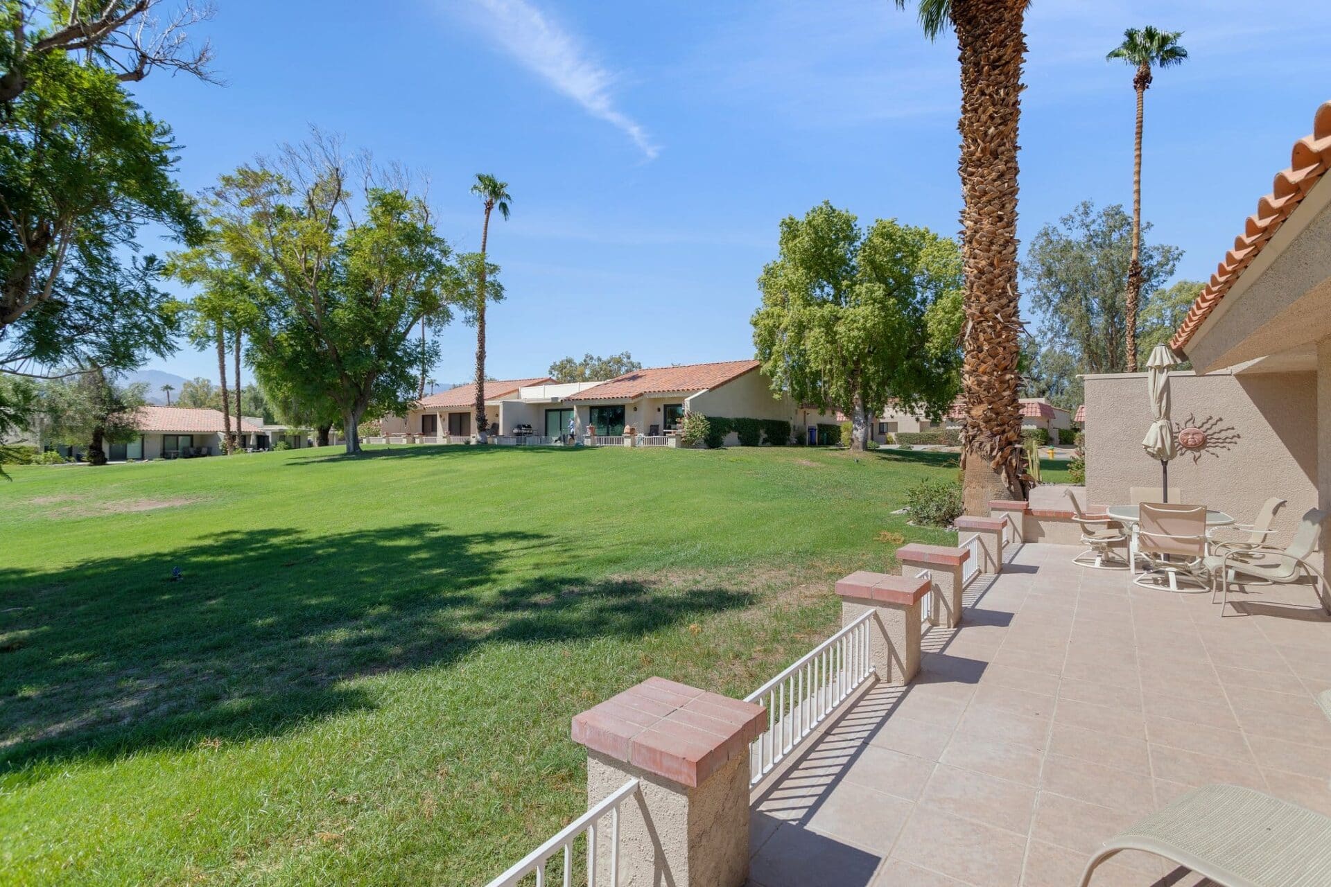Rear view from patio of yard and homes in the area at 40386 Pebble Beach