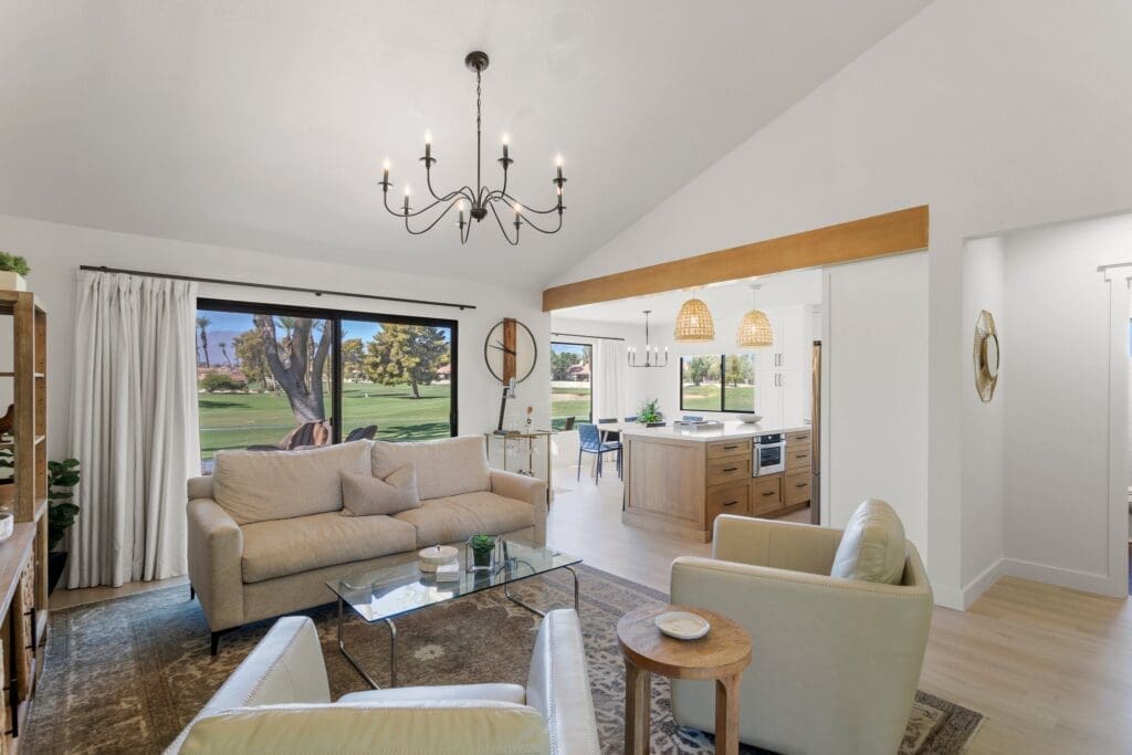 Living area with white couches overlooking the kitchen at 41443 Inverness Way