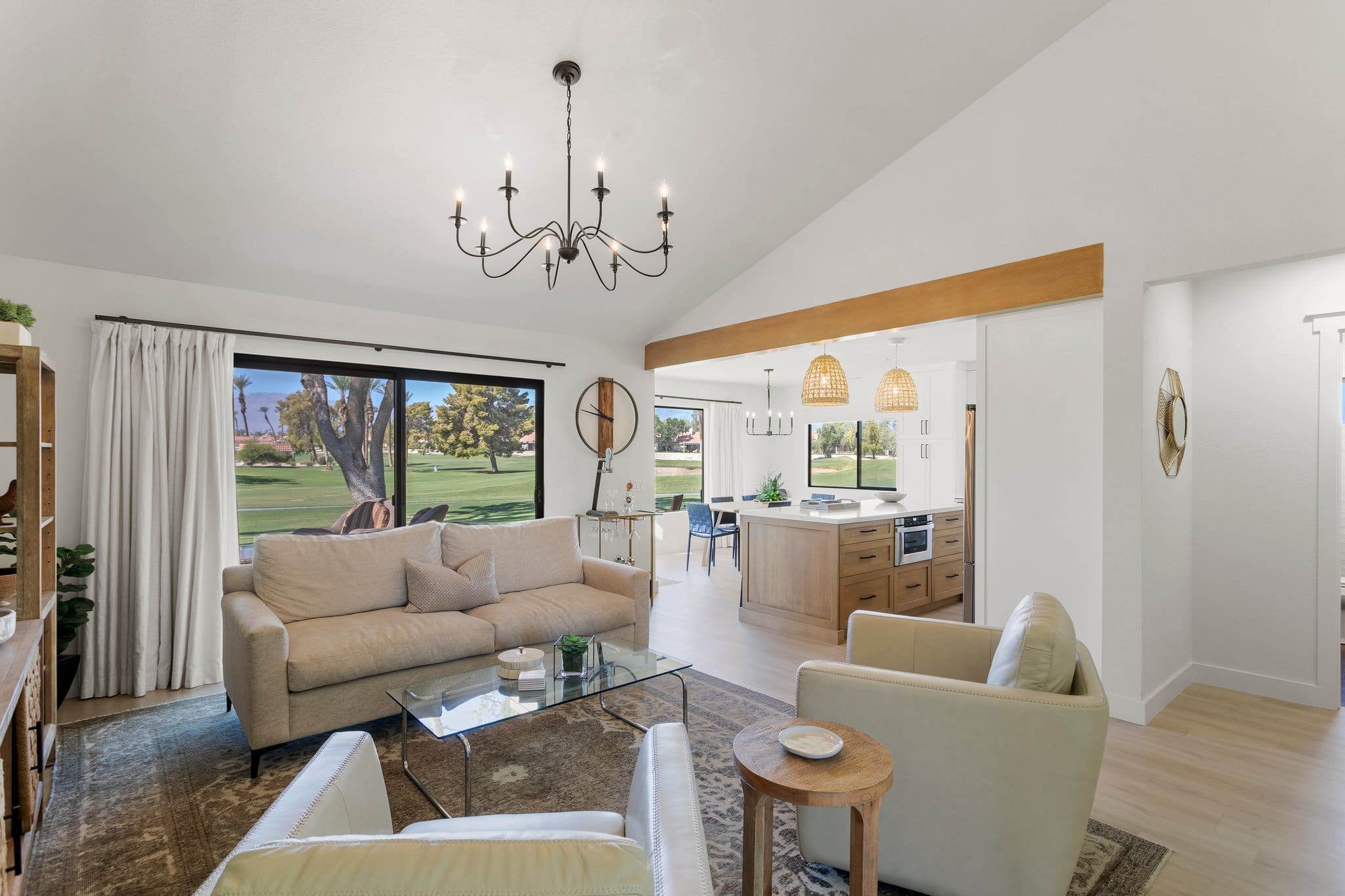 Living area with white couches overlooking the kitchen at 41443 Inverness Way