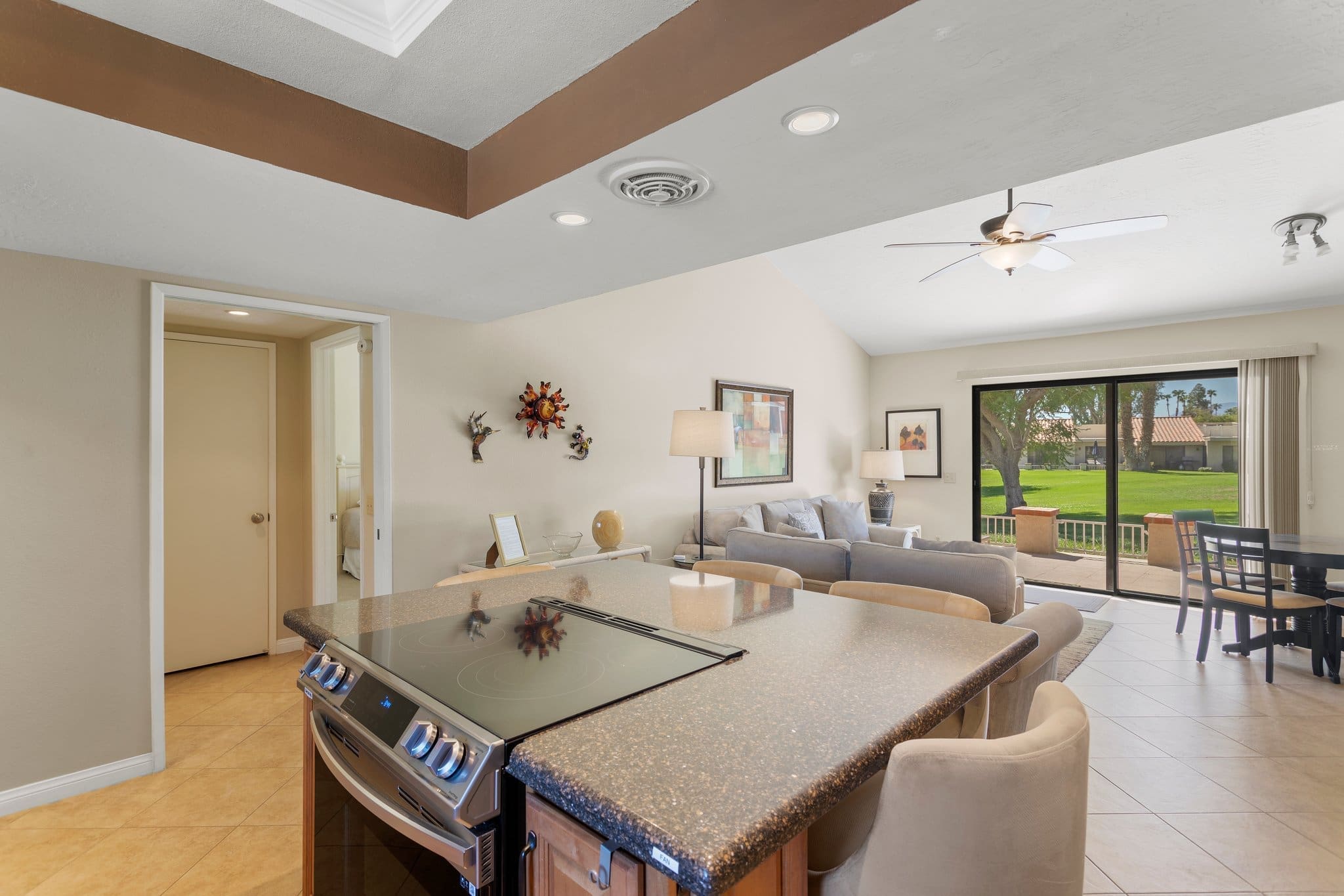View from kitchen area overlooking living room with sliding glass doors at 40386 Pebble Beach