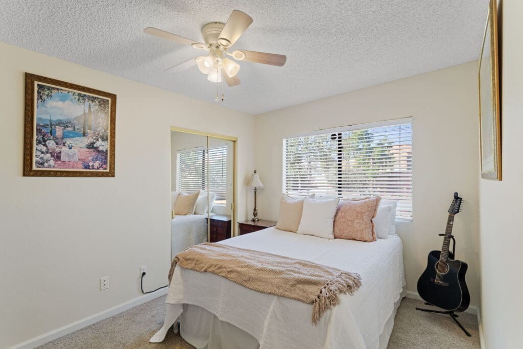 Side view of guest bedroom and glass sliding doors to closet at 77042 Pauma Valley Way