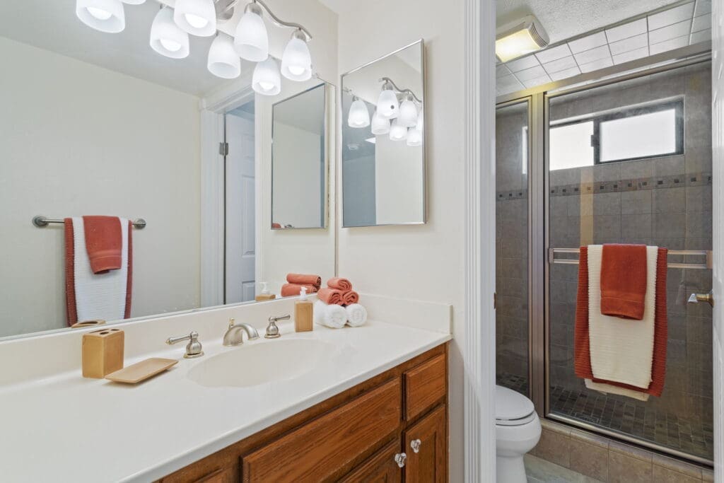 View of bathroom from kitchen sink to include toilet and shower at 77042 Pauma Valley Way