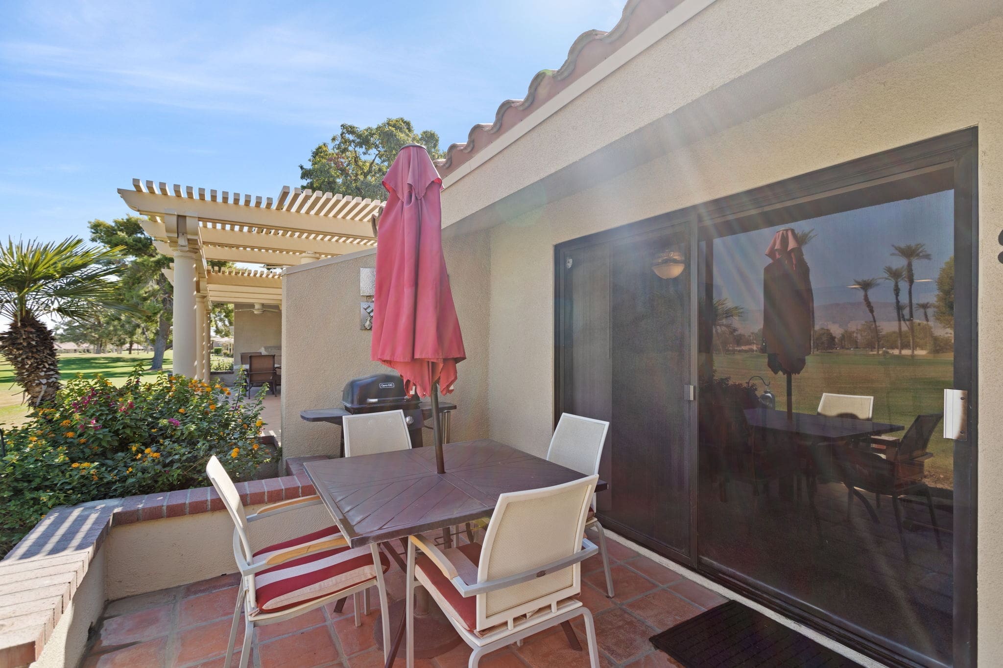 Back patio with table and chairs at 77042 Pauma Valley Way