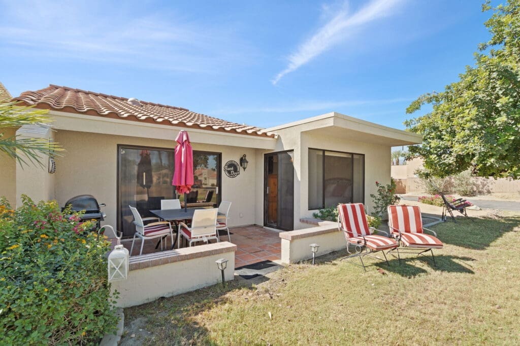 Exterior rear view of back patio and sliding door at 77042 Pauma Valley Way