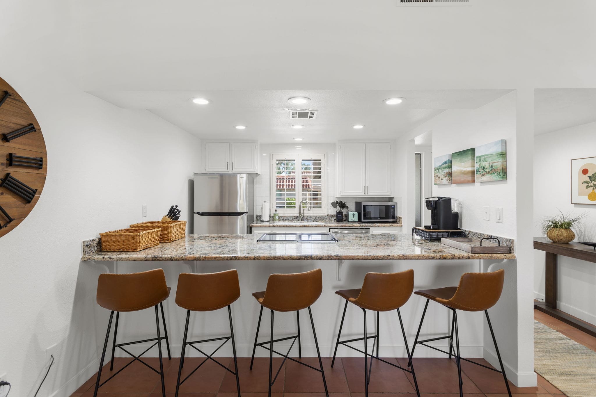 Kitchen island with chairs and overview of kitchen at 41447 Inverness Way