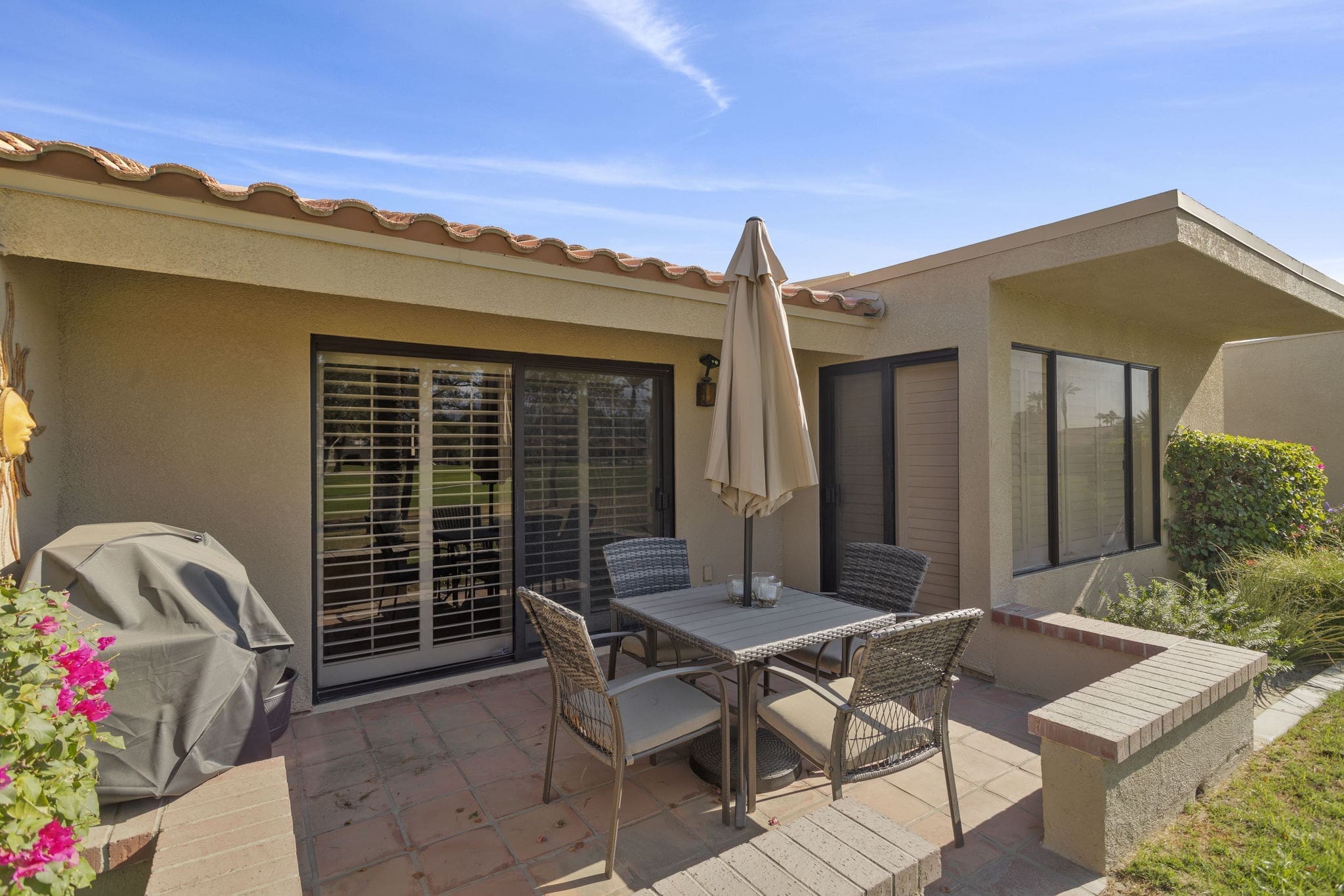 Back patio with patio set and grill at 41447 Inverness Way