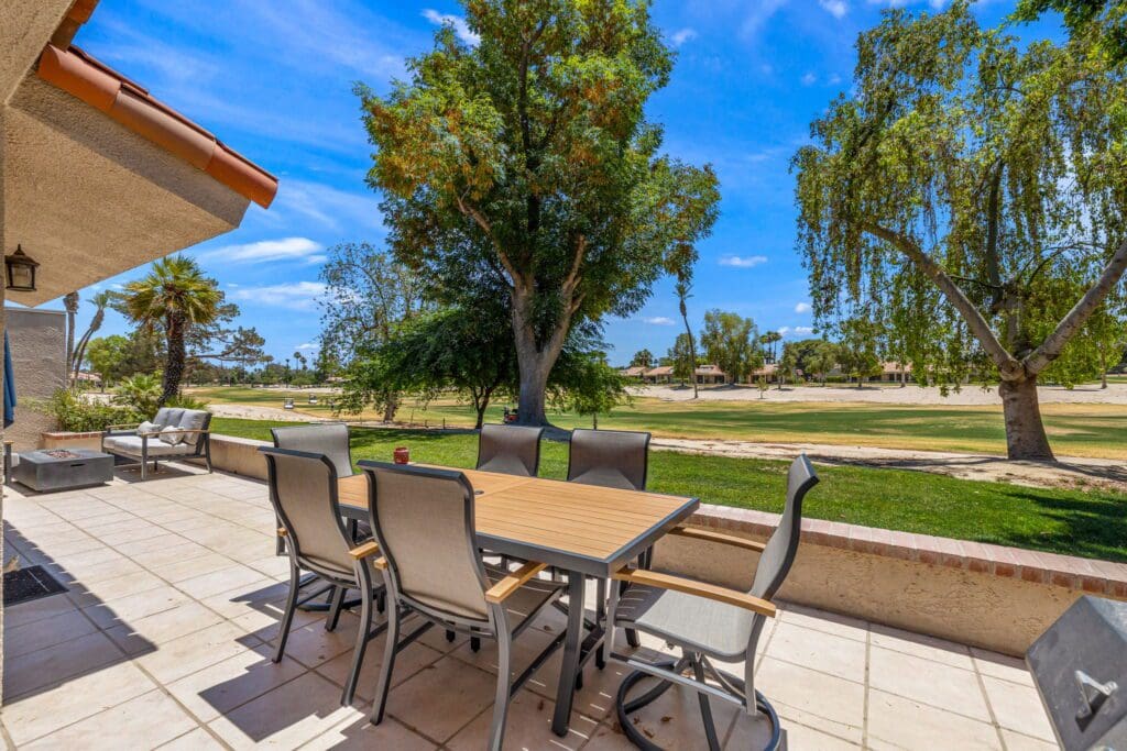 table and chair on patio with golf course view