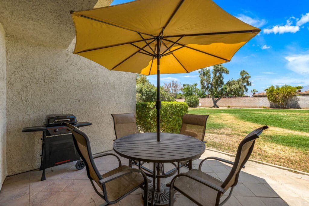 patio set with yellow umbrella