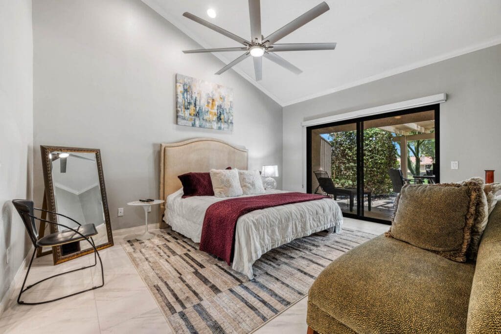 2nd bedroom with couch and view to patio