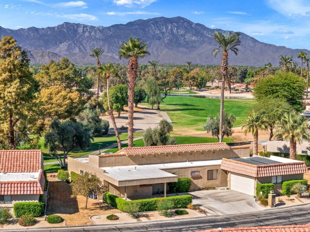 home with mountain range in rear