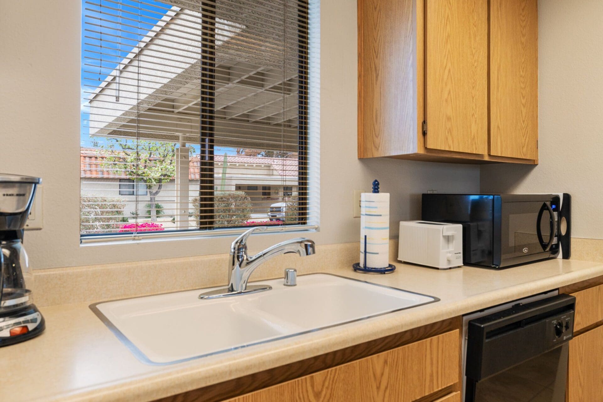 kitchen sink, coffee maker, microwave and toaster