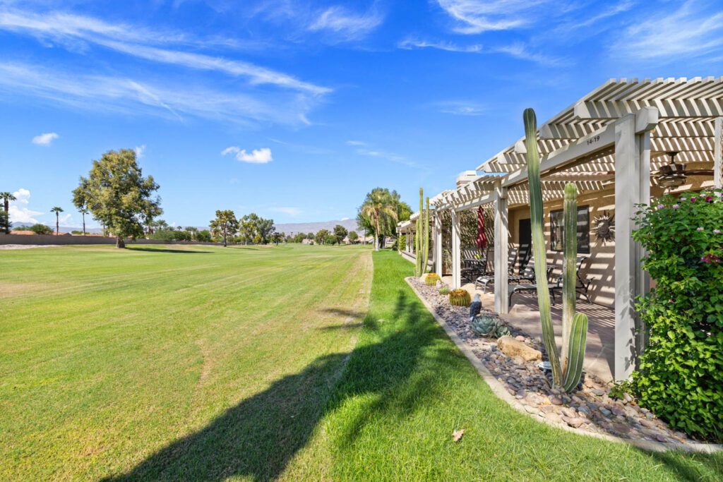 view of green with patio